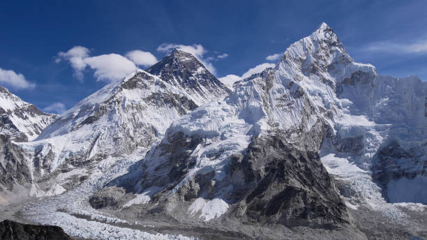 Stunning view of mighty Mount Everest (peak 8,848 m) and the west side of Nuptse (7,861 m) with the famous Khumbu ice fall below viewed from Kala Patthar in the Himalayas, Nepal. stock photo