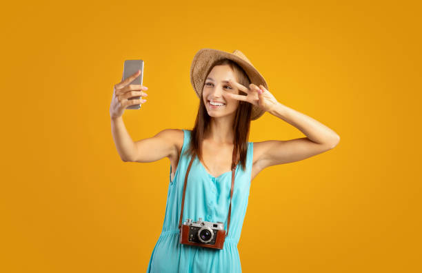 istock Pretty young lady traveller taking selfie on mobile phone 1284079241