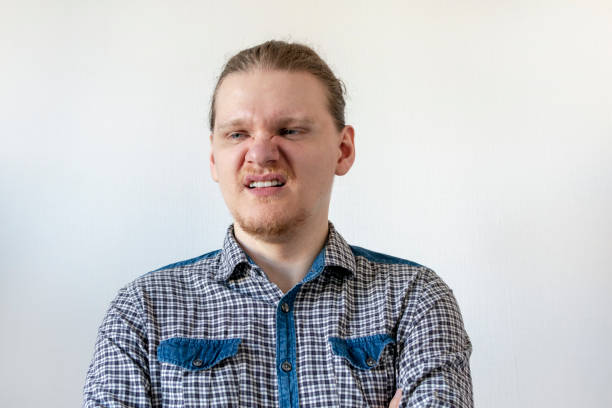 istock Disgusted man in a plaid shirt. isolate on white background 1284082052