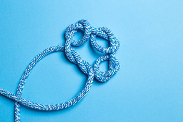 istock Knots on a rope on a blue background. 1284082075