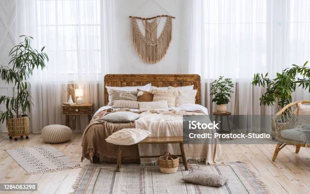 Rustic Home Design With Ethnic Boho Decoration Bed With Pillows Wooden Furniture Stock Photo - Download Image Now