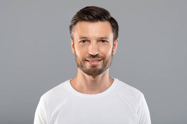 istock Portrait of handsome cheerful man on grey 1284084192