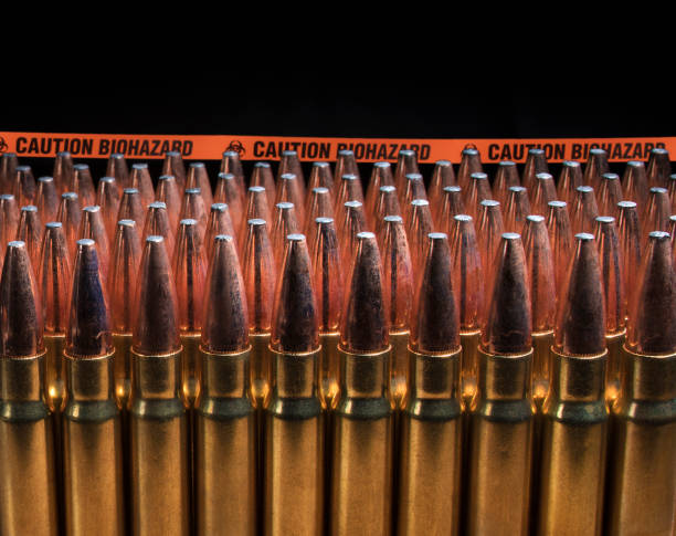 istock Biohazard tape behind a line of ammunition 1284084844