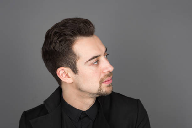 istock Studio portrait of a young man in a black jacket against plain studio background 1284084980