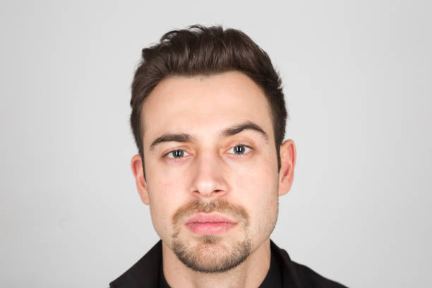 istock Studio portrait of a young man in a black jacket against plain studio background 1284084988
