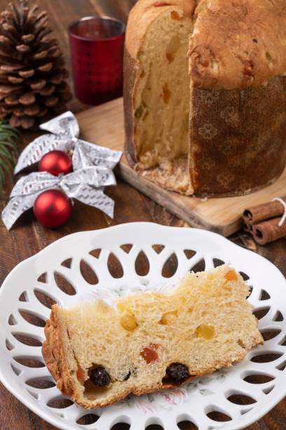 istock Traditional italian christmas fruit cake panettone with slice on a plate 1284085083