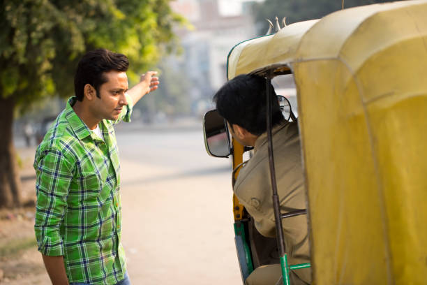 istock Man hailing auto rickshaw in city 1284086486