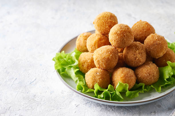 istock Fried cheese balls, appetizer with herbs and sauces in a plate on a gray table Copy space 1284088627