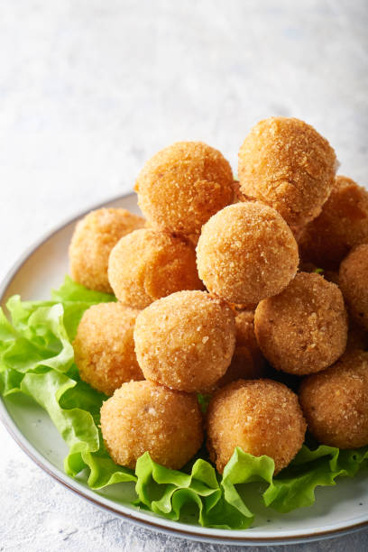 istock Fried cheese balls, appetizer with herbs and sauces in a plate on a gray table Copy space 1284088644