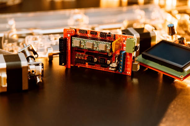 istock a set of different parts for a laser machine on a black background, orange illumination, flat lay. open-source hardware and software board for controlling the machine and v slot aluminum profile lies 1284089498