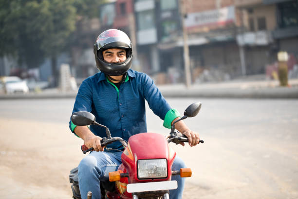 istock Man riding motorcycle on city street 1284089812