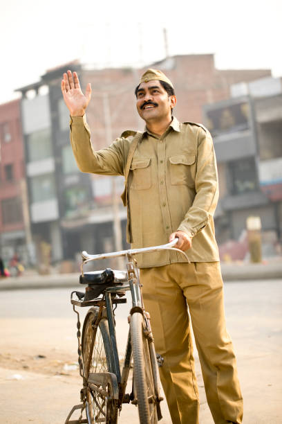 istock Postal worker with bicycle on street 1284089864