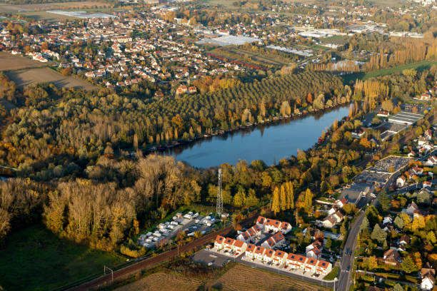 Egly seen from the sky in autumn, France. Egly, France - October 30, 2015: Aerial view of Egly, pond on the big island, Essonne department, Ile-de-France region, France essonne stock pictures, royalty-free photos & images