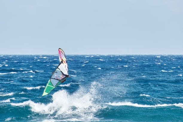 istock Windsurfing jumps out of the water 1284090101