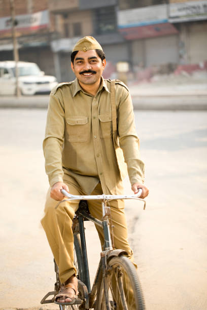 istock Postal worker with bicycle on street 1284090140