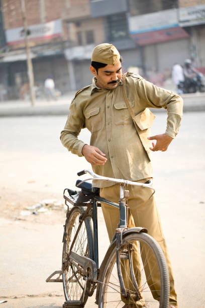 istock Postal worker with bicycle on street 1284090184
