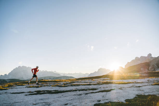 istock Male trail runner traverses mountain ridge crest 1284090744
