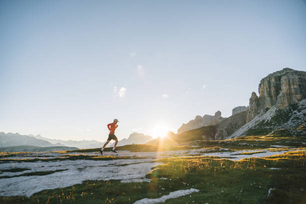 istock Male trail runner traverses mountain ridge crest 1284090883