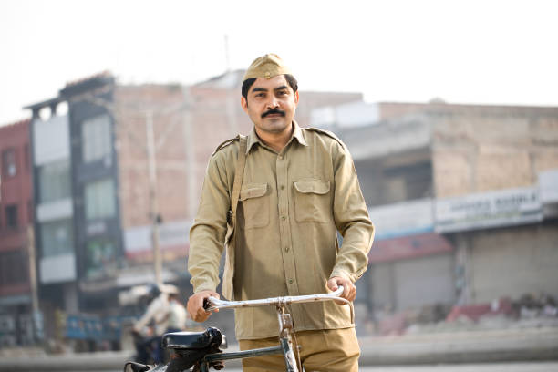 istock Postal worker with bicycle on street 1284090904