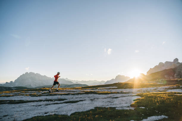 istock Male trail runner traverses mountain ridge crest 1284090915