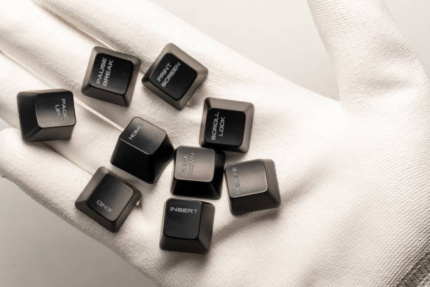 istock black keyboard buttons with white inscriptions on a hand in a white glove on a white background 1284091174