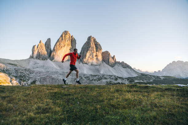 istock Male trail runner traverses mountain ridge crest 1284091364