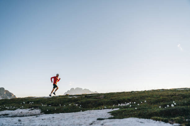 istock Male trail runner traverses mountain ridge crest 1284091506