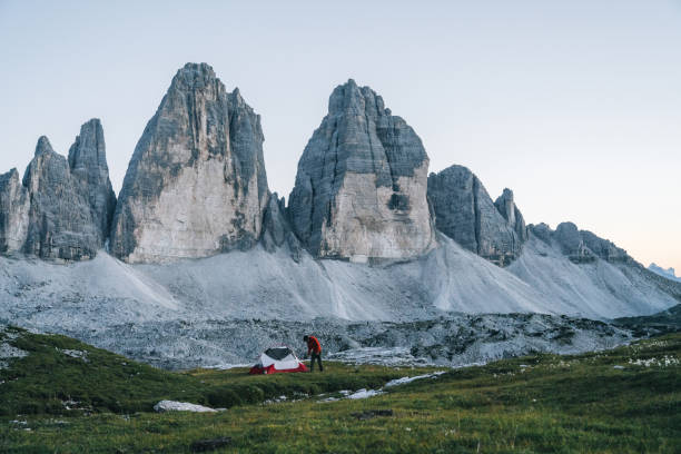 istock Male hiker camps out on mountain ridge crest 1284091532