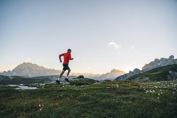 istock Male trail runner traverses mountain ridge crest 1284091535