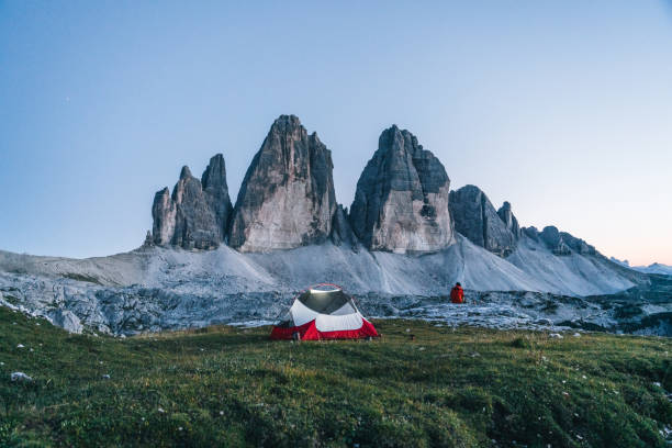 istock Male hiker camps out on mountain ridge crest 1284092208