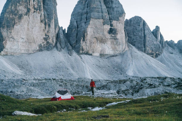 istock Male hiker camps out on mountain ridge crest 1284092218