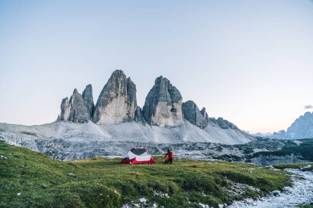 istock Male hiker camps out on mountain ridge crest 1284092242