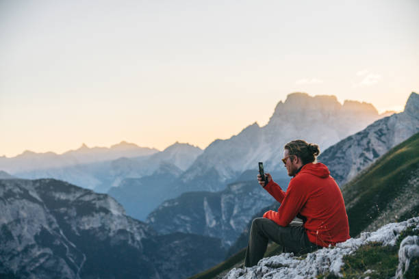 istock Male hiker relaxes on mountain ridge crest 1284092261