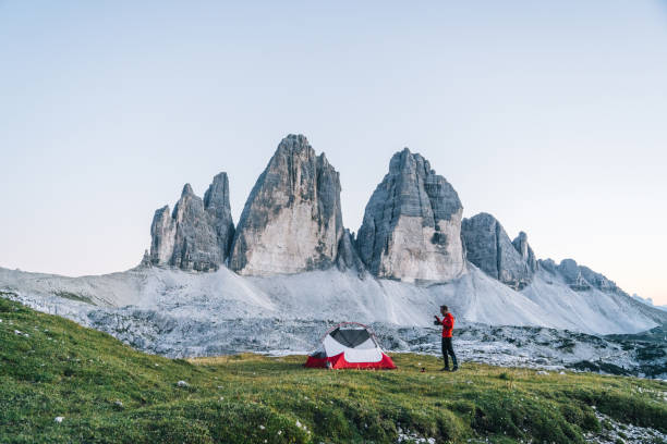 istock Male hiker camps out on mountain ridge crest 1284092427