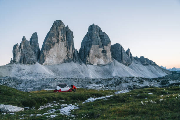 istock Male hiker camps out on mountain ridge crest 1284092458