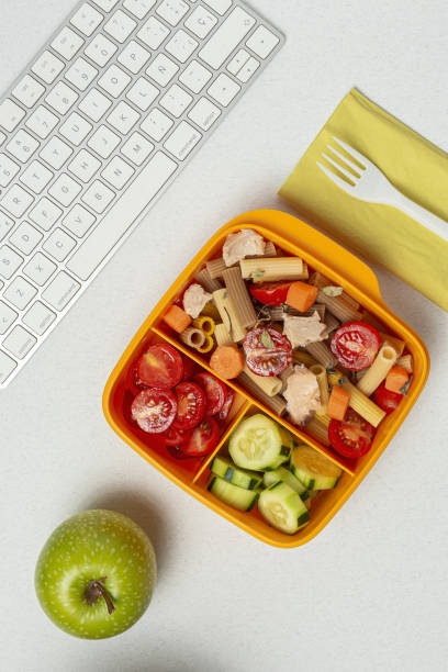 istock Lunch at workplace healthy pasta with tuna, tomatoes, in lunch box 1284092515