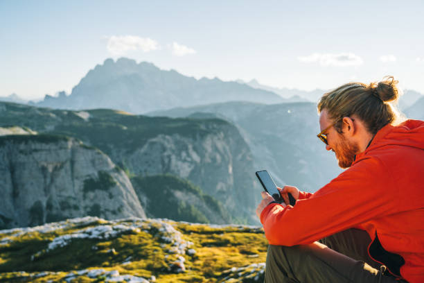 istock Male hiker relaxes on mountain ridge crest 1284092577