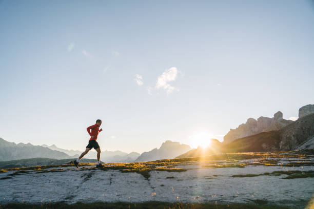 istock Male trail runner traverses mountain ridge crest 1284092872