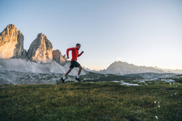 istock Male trail runner traverses mountain ridge crest 1284093506