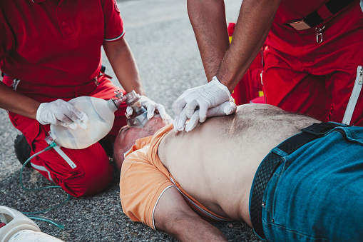 Paramedic giving assistance to a patient with respiratory failure.