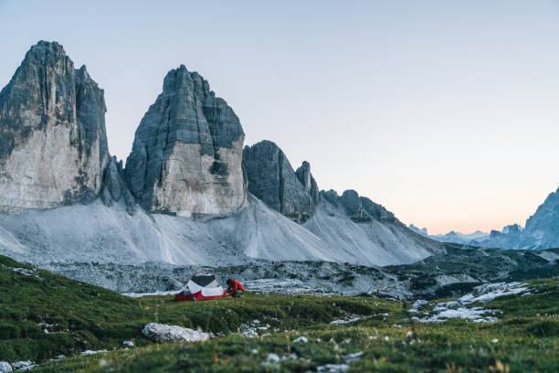 istock Male hiker camps out on mountain ridge crest 1284093605