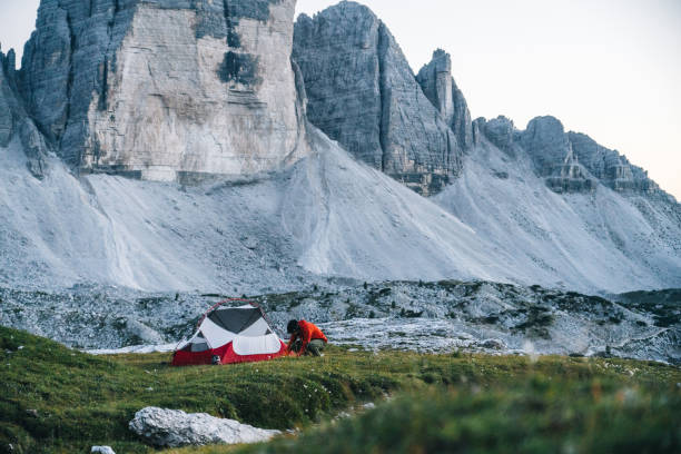 istock Male hiker camps out on mountain ridge crest 1284093769