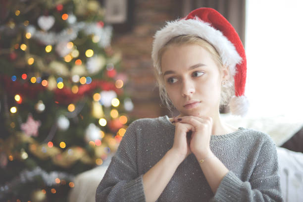 istock young woman in christmas interior ( negative emotions) 1284093927