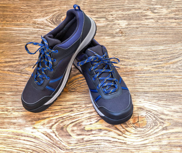 istock black outdoor sneakers on wooden surface 1284094096
