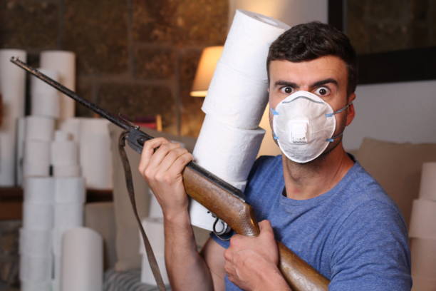 istock Man hoarding toilet paper defending his pile 1284094228