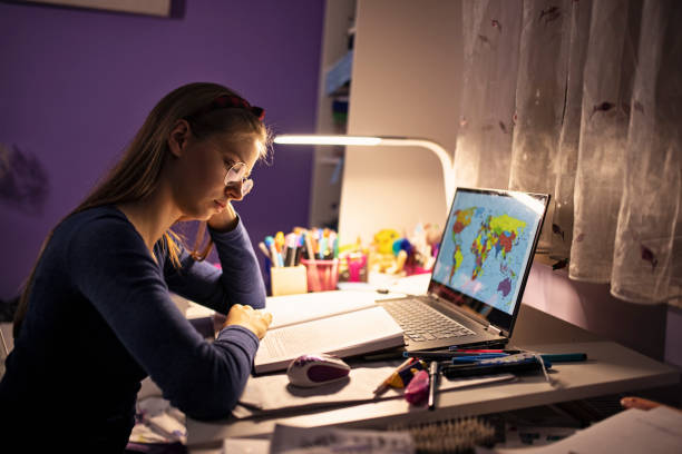 Teenage girl studying at home Teenage girl studying at her desk in her room. She is using task lighting to save the energy.
Shot with Canon R5 desk lamp photos stock pictures, royalty-free photos & images