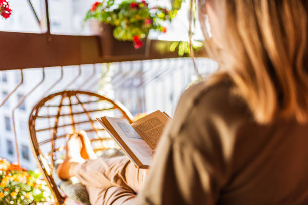 istock Woman reading a book on a terrace 1284095231