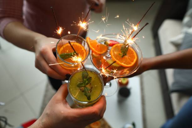 istock Three people hold glasses and clink glasses. 1284095503