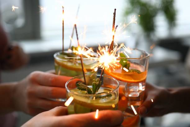istock Three alcoholic cocktail with fruit pieces, mint and sparklers close up. 1284095507