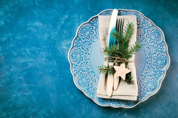 istock Vintage cutlery on a blue plate - eco friendly new year dinner concept 1284095538
